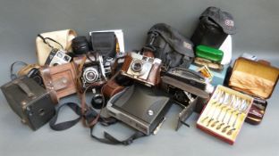 A quantity of collectable cameras to include Canon EOS 300v with 28-105mm lens and 75-300mm lenses,