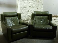 A pair of leather arm chairs,