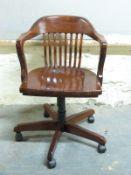 A stained beech office chair with swivel mechanism