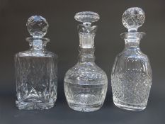Three cut glass decanters comprising a Waterford Crystal Lismore pattern example,