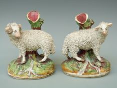 A pair of 19thC Staffordshire sheep spill vases,