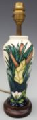 Moorcroft lamp base decorated with lilies in the Lamia pattern,