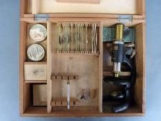 A Milbro cased field/student's microscope and slides
