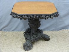 A 19thC satinwood table raised on an unusual burr wood base,