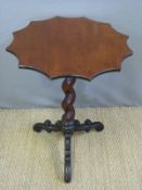 A Victorian mahogany table on spiral stem with carved triform base