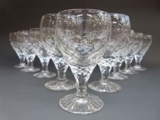 A set of eight wine glasses, all with cut stems and star cut bases, six 13cm and two 14.5cm tall.