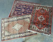 Three rugs including an Iranian Hamadan example,