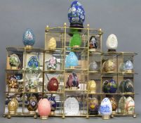 A quantity of decorative eggs including glass, cloisonné,