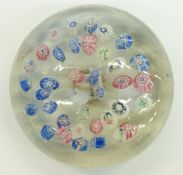St Louis style glass paperweight with various scattered multi-coloured canes, 75mm in diameter.