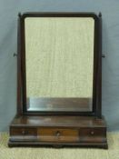 A Georgian mahogany swing frame toilet mirror with bevelled glass,