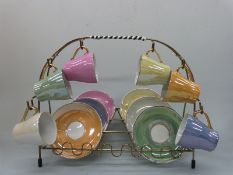 A retro harlequin coloured lustre tea set on stand and a lemonade set