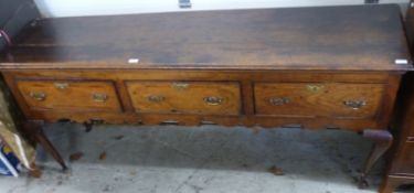 A Georgian crossbanded oak three drawer sideboard,