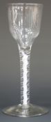 An 18thC cotton twist cordial glass with ogee bowl, multi-spiral stem and stepped foot, 15.5cm tall.