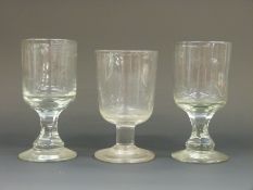Three Georgian rummers comprising a pair with cut stems (14.5cm tall) and one with stepped foot (13.