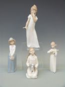 Four Lladro figures of children,