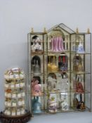 A Franklin Mint ceramic and glass bell collection in mirrored frame and a thimble collection with