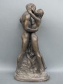 Bronzed figure of a couple embracing,