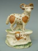 An 18thC Staffordshire figure of a ram and lamb, label to base Alistair Sampson Antiques B.A.D.A.
