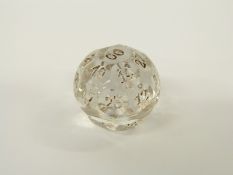A glass multi-faceted gaming teetotum with individually numbered panels, 2.7cm in diameter.