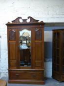 A late 19thC walnut mirror door wardrobe with drawer below,