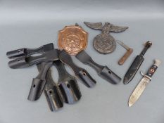 A quantity of Nazi German reproduction insignia including Hitler Youth knife and copper fire or