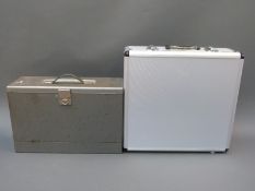 Two metal carry cases one with padded interior, lockable clasps and keys.