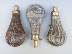 Three embossed powder flasks, two with decoration of stags and game birds,