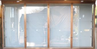 Ex Victoria & Albert Museum early 20thC four door glass display cabinet with bronzed frame.