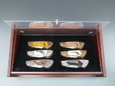 A set of six Franklin Mint pocket knives featuring American Colt pistols,