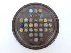 Thirty-two handmade glass marbles all with multi-coloured latticino decoration,