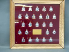A framed set of 25 hallmarked silver and enamel Royal Air Force Squadron badges commemorating the