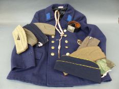 A quantity of military caps some with Nazi insignia, belt,