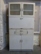 A retro 1950s kitchen cabinet with fold down surface and fitted interior,