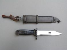 A 20thC Egyptian bayonet, scabbard and frog, the blade with serrated edge and wire cutting feature,