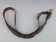 A leather and brass powder or shot flask belt