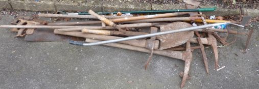 A collection of garden and other tools including saw,
