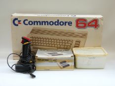 Commodore 64 with various accessories and games, in original box.