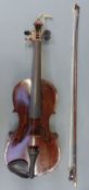 A late 19thC / early 20thC cased violin with 33cm two-piece back, complete with bow,
