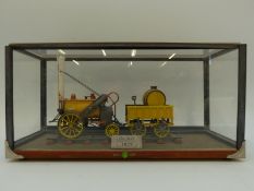 A scratch built model of Stephenson's Rocket in perspex display case,