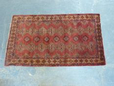 An Eastern rug with stylised decoration,