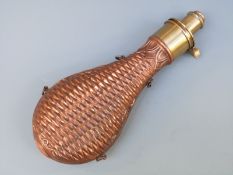 Sykes copper and brass powder flask with embossed geometric and acanthus leaf decoration and four
