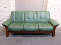 A Stressless three seater green leather sofa