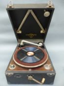 A Columbia vintage wind-up portable gramophone in black Rexine finish together with a folder of
