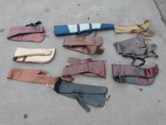 Ten various gun slips / cases, some leather and some padded.