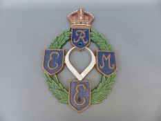 A cast iron REME emblem with King's crown to top,
