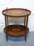 A late 19thC/ early 20thC two tier tea stand or similar occasional table,