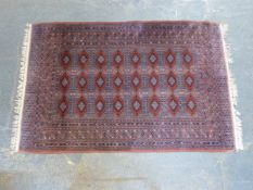 An Eastern wool rug with repeating geometric design,