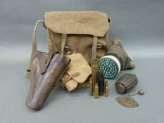 A gas mask dated 10-39, leather pistol holster, instructional grenade,
