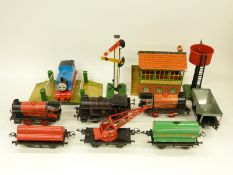 Three Hornby 0 gauge clockwork locomotives, nine wagons and coaches, water tower,