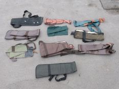 Ten various gun slips / cases, some leather and some padded.